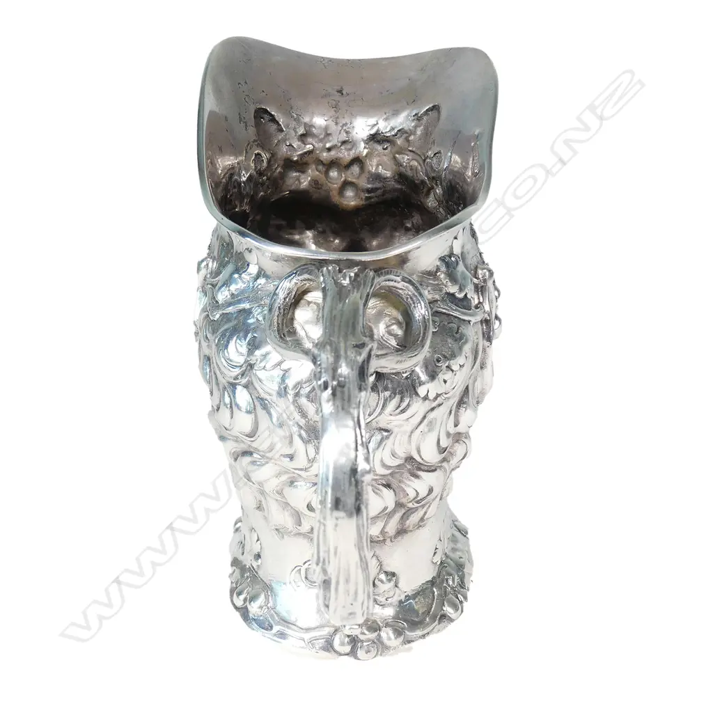 A cast silver wine jug modelled as a portrait mask of Bacchus Image 1++