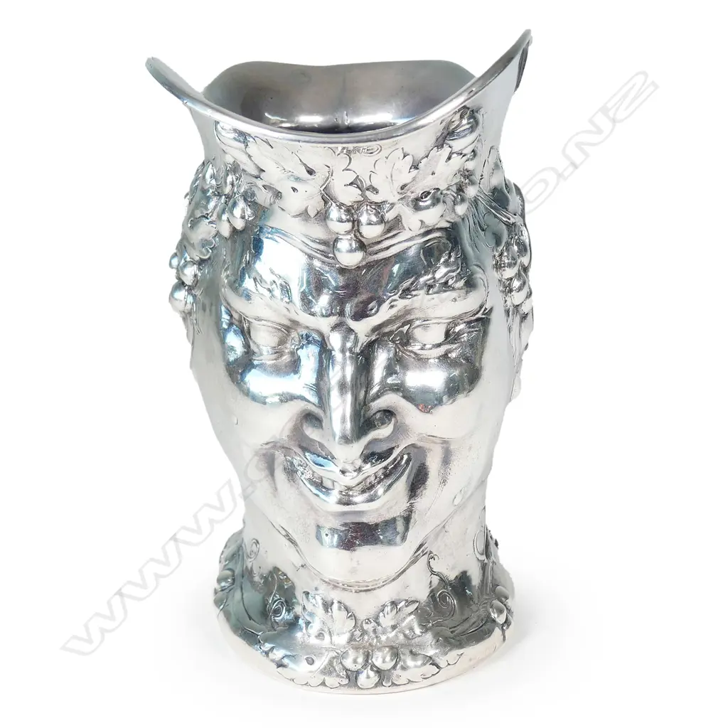 A cast silver wine jug modelled as a portrait mask of Bacchus Image 1++