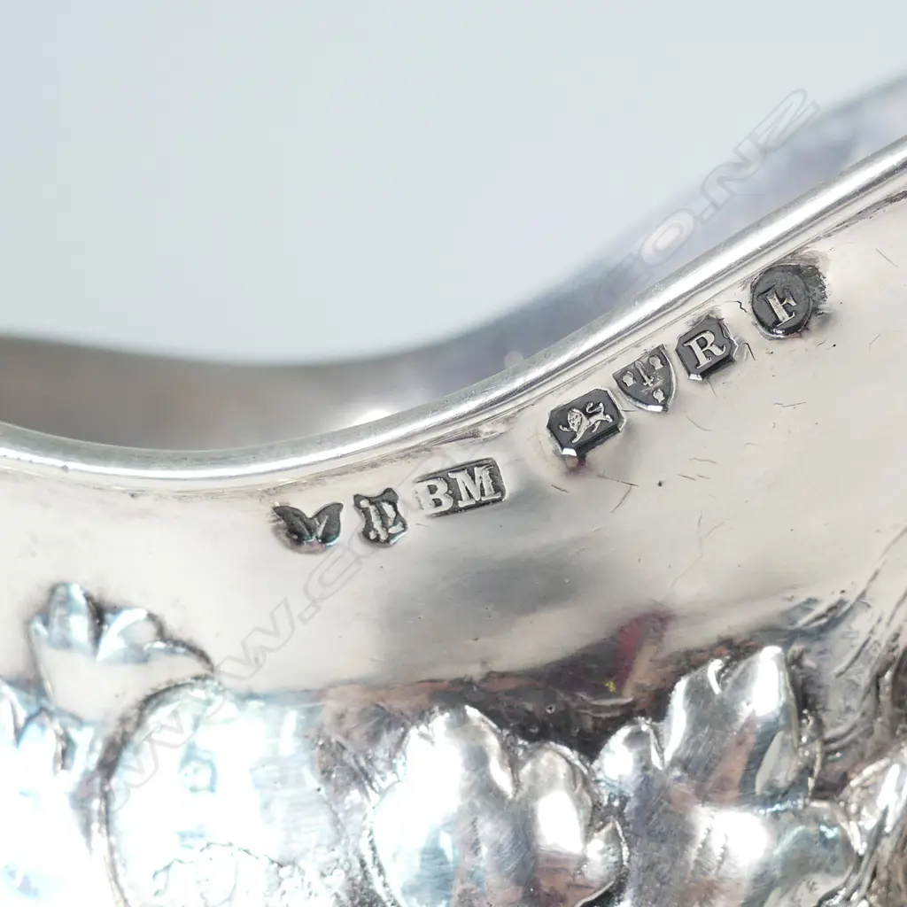 A cast silver wine jug modelled as a portrait mask of Bacchus Image 1++