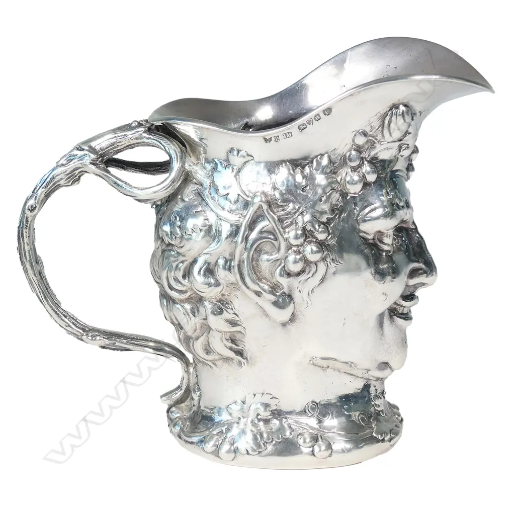 A cast silver wine jug modelled as a portrait mask of Bacchus Image 1++