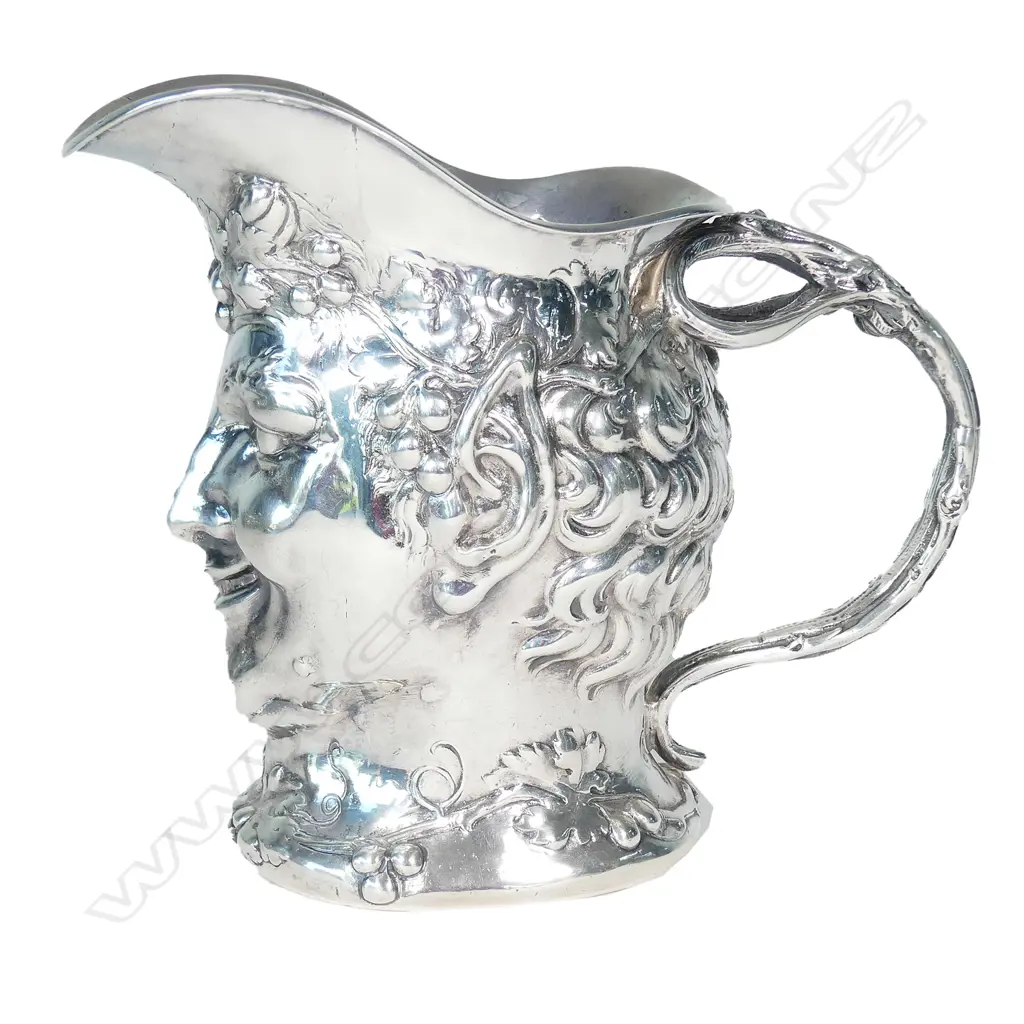 A cast silver wine jug modelled as a portrait mask of Bacchus Image 1++