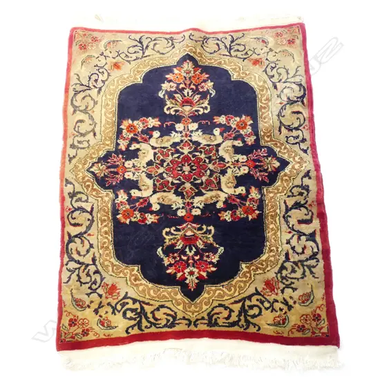 A Persian Kerman small hand knotted rug