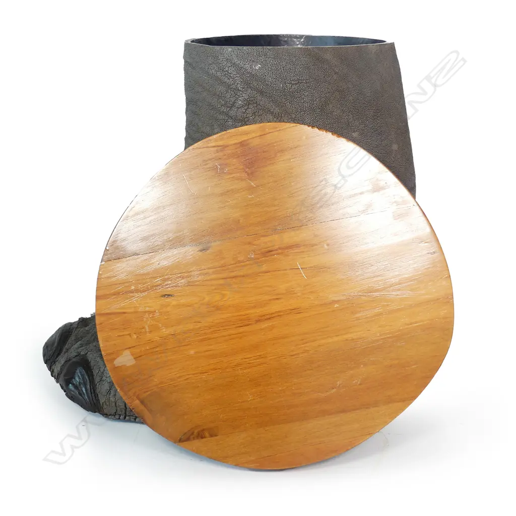 An occasional table fashioned from an elephant foot with fitted wooden top Image 1++