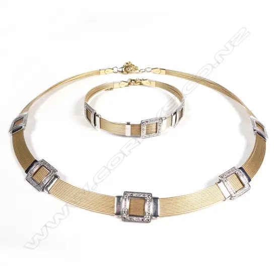 A stylish modern 14ct. yellow and white gold necklace and matching bracelet