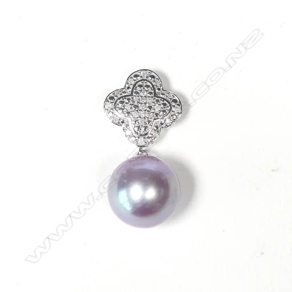 A 14ct white gold diamond and pearl pendant Image 1++