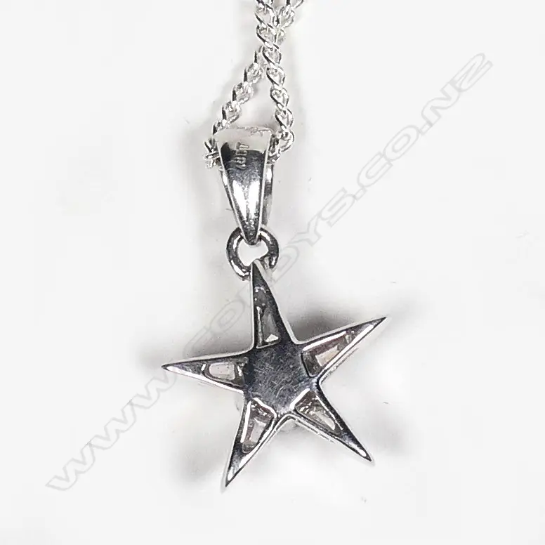 An 18ct. white gold and diamond set star pendant on chain Image 1++
