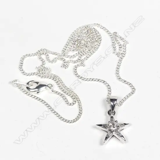 An 18ct. white gold and diamond set star pendant on chain