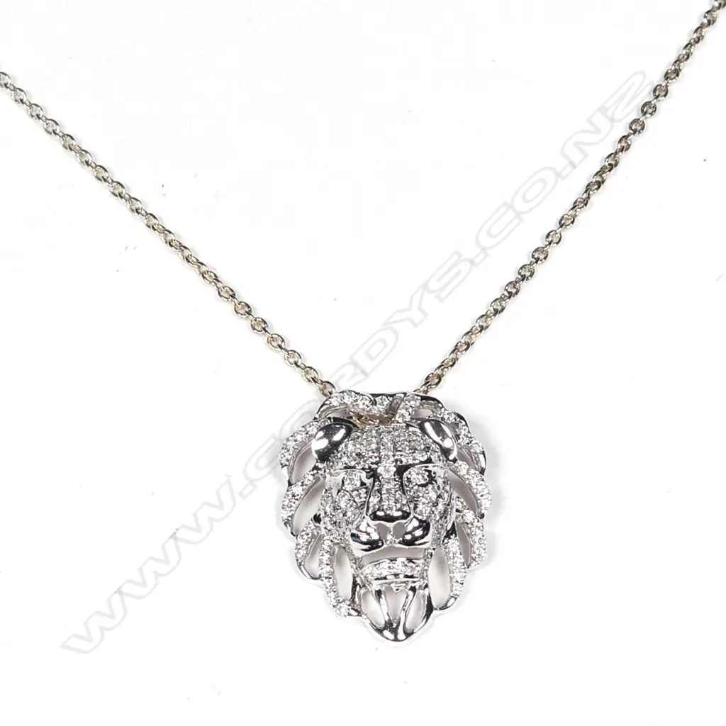 An 18ct. white gold and diamond set lion mask pendant on chain Image 1++