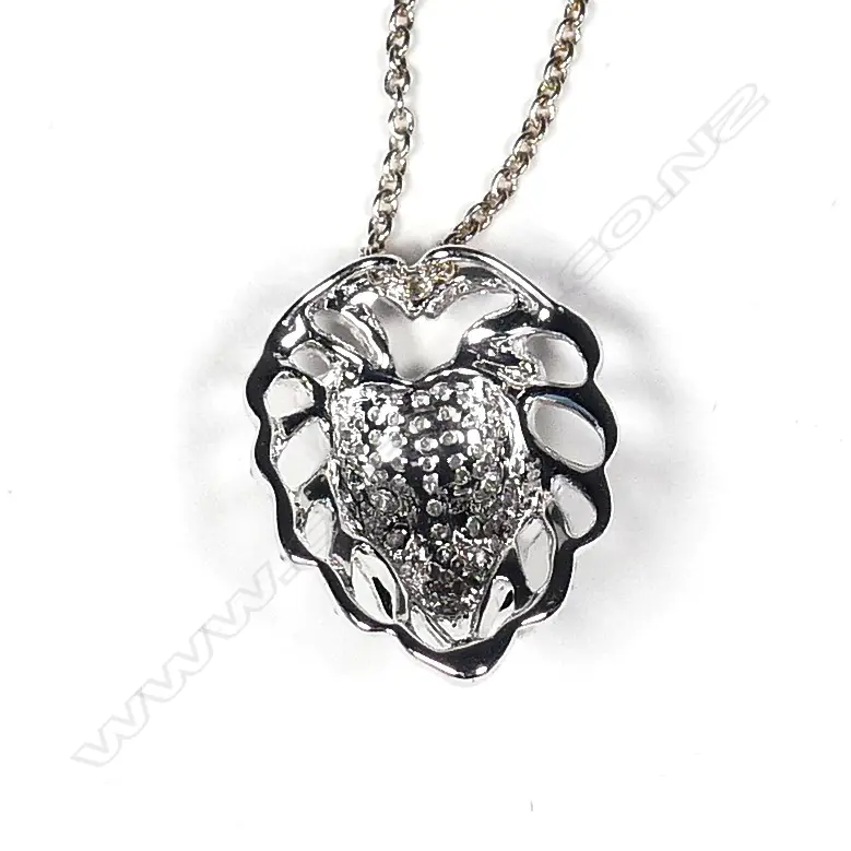 An 18ct. white gold and diamond set lion mask pendant on chain Image 1++