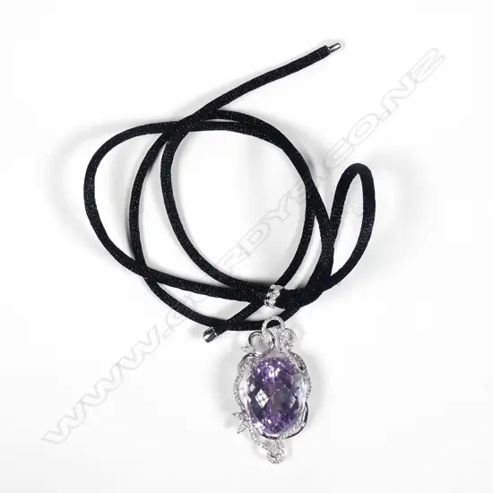 An impressive 18ct white gold large oval facet cut amethyst and diamond pendant