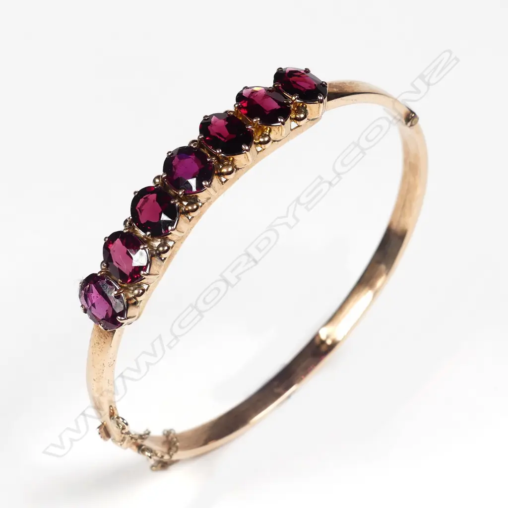 An Edwardian 9ct rose gold and almandine garnet hinged bangle Image 1++