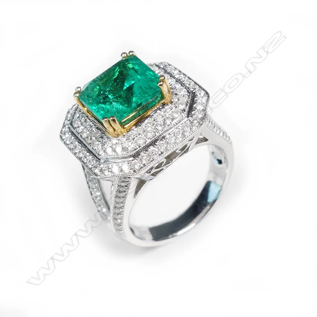 An impressive 18ct white gold emerald and diamond ring Image 1++