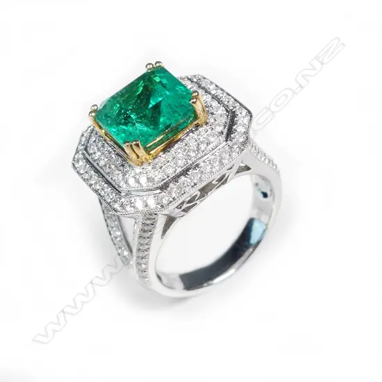 An impressive 18ct white gold emerald and diamond ring