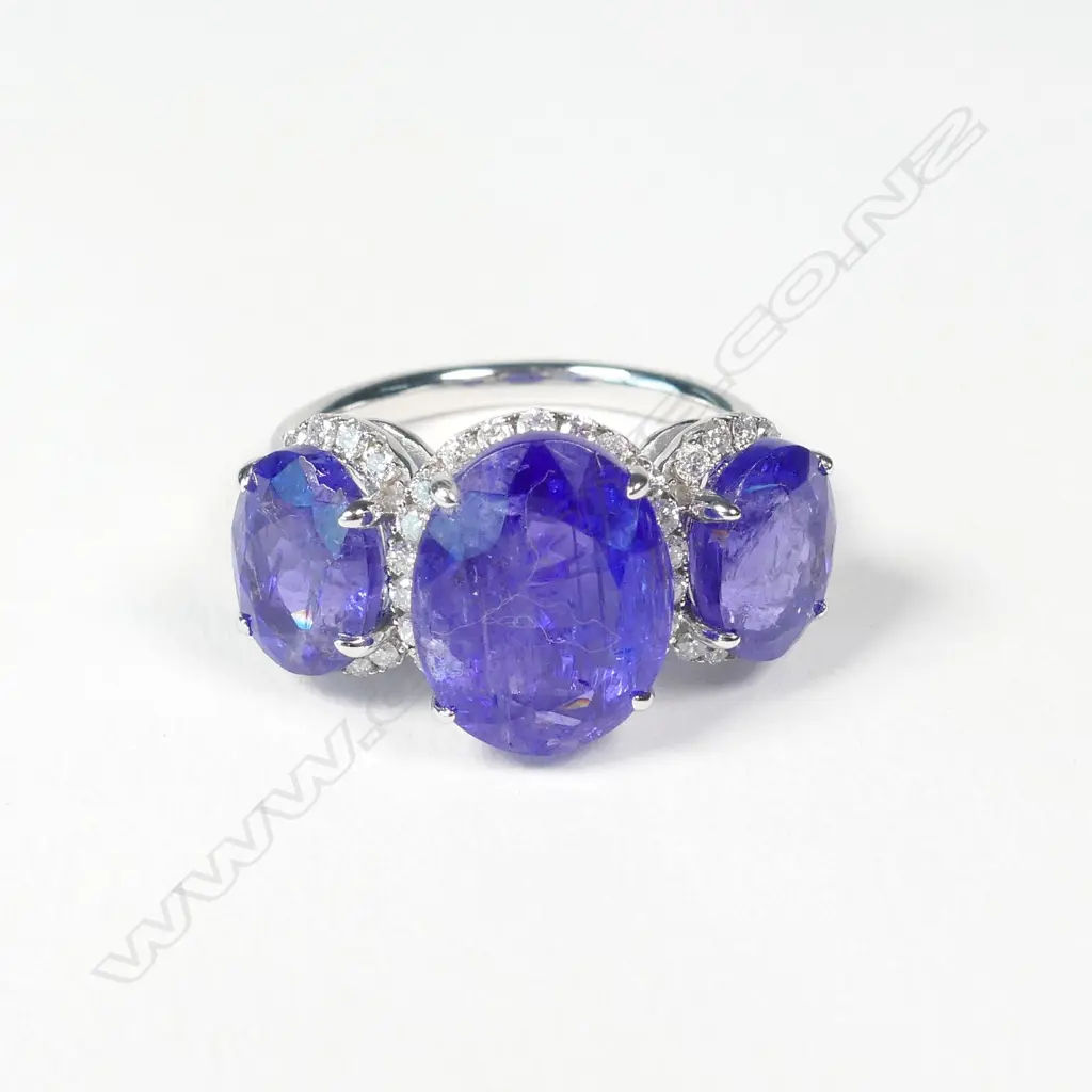 A 14ct white gold tanzanite and diamond trilogy ring Image 1++