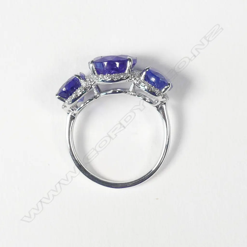 A 14ct white gold tanzanite and diamond trilogy ring Image 1++