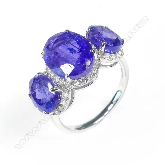 A 14ct white gold tanzanite and diamond trilogy ring