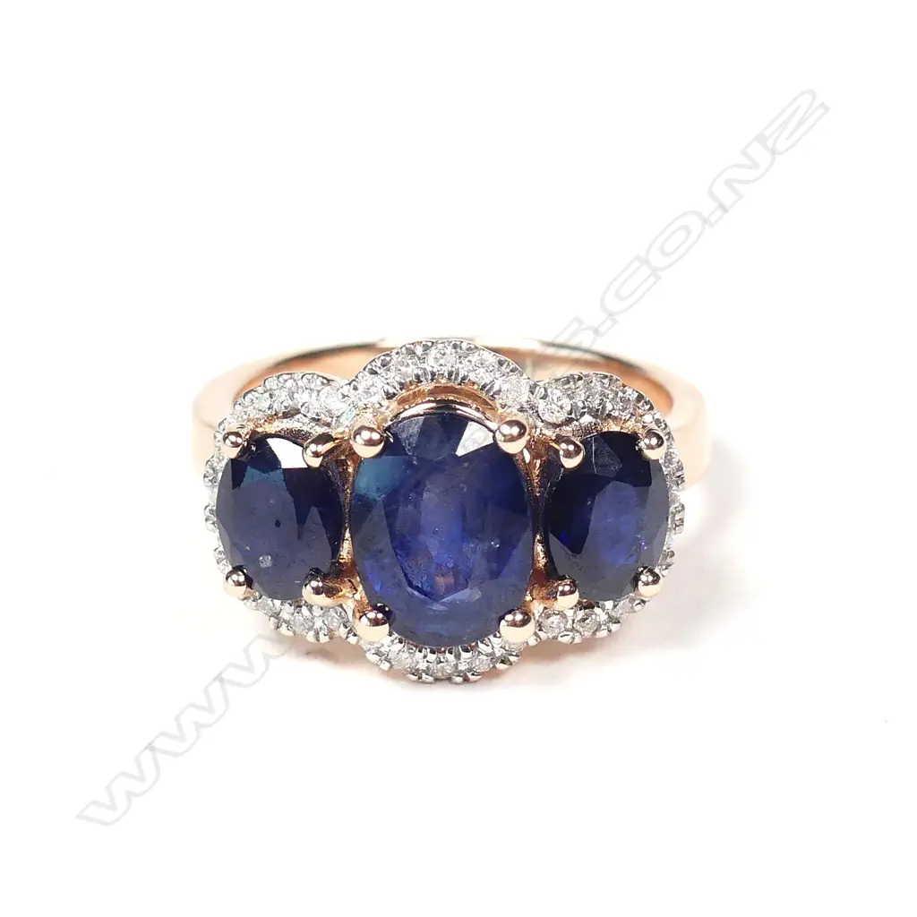 A 14ct rose gold sapphire and diamond trilogy ring Image 1++