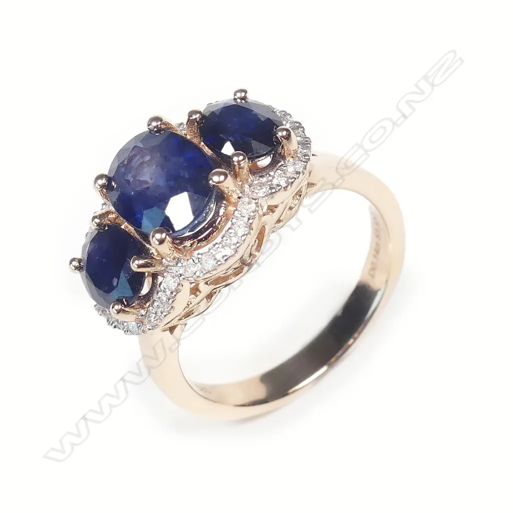 A 14ct rose gold sapphire and diamond trilogy ring Image 1++