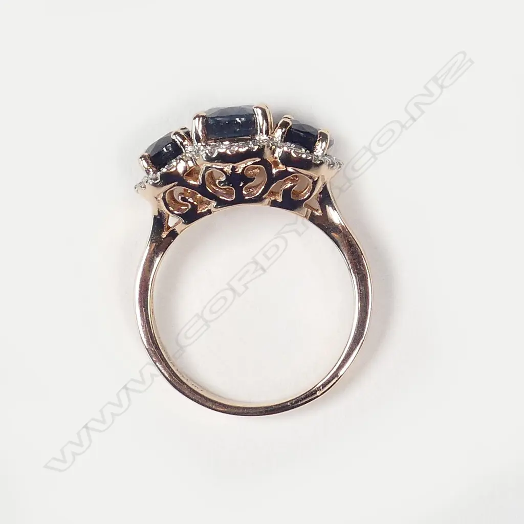 A 14ct rose gold sapphire and diamond trilogy ring Image 1++
