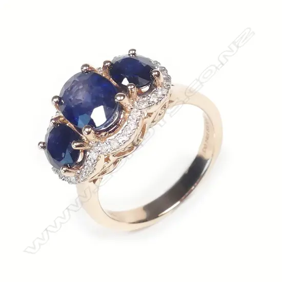 A 14ct rose gold sapphire and diamond trilogy ring