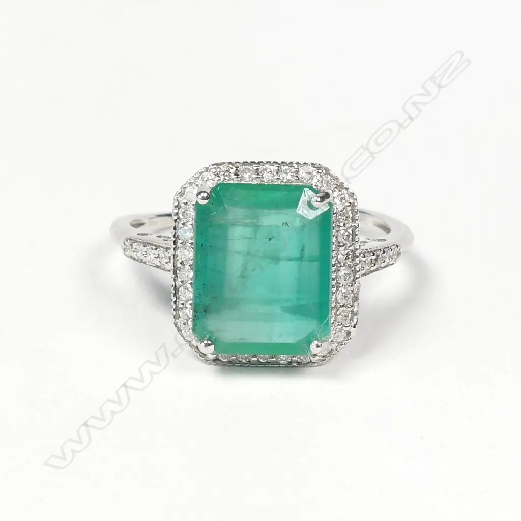 A 14ct white gold emerald and diamond ring Image 1++
