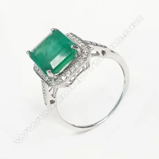 A 14ct white gold emerald and diamond ring