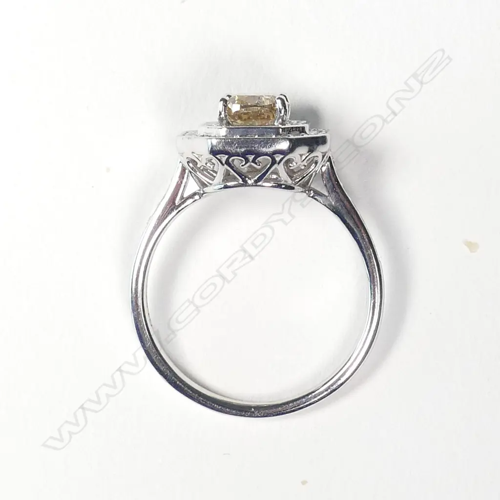 A 14ct white gold and diamond halo ring Image 1++