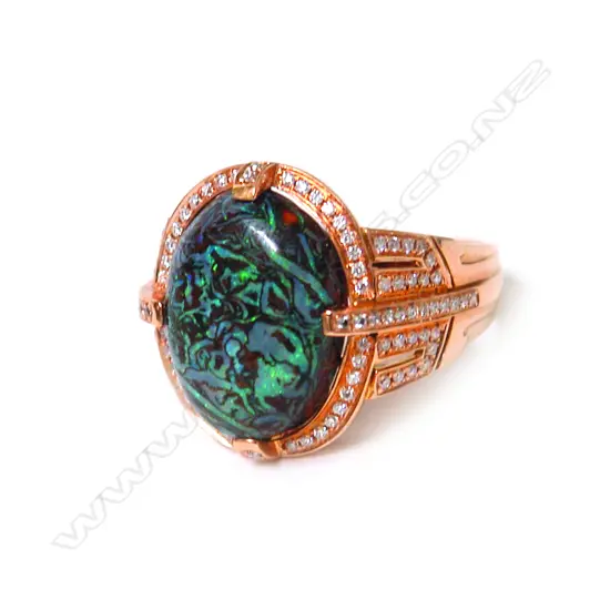 A modern 18ct. rose gold rock opal and diamond dress ring