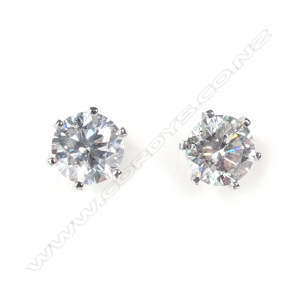 A pair of 14ct white gold and diamond stud earrings Image 1++