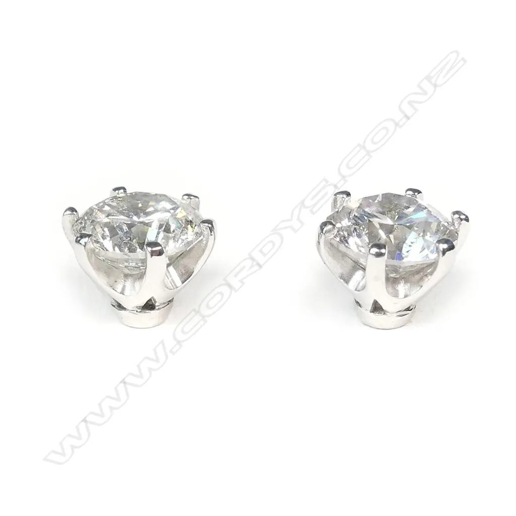 A pair of 14ct white gold and diamond stud earrings Image 1++