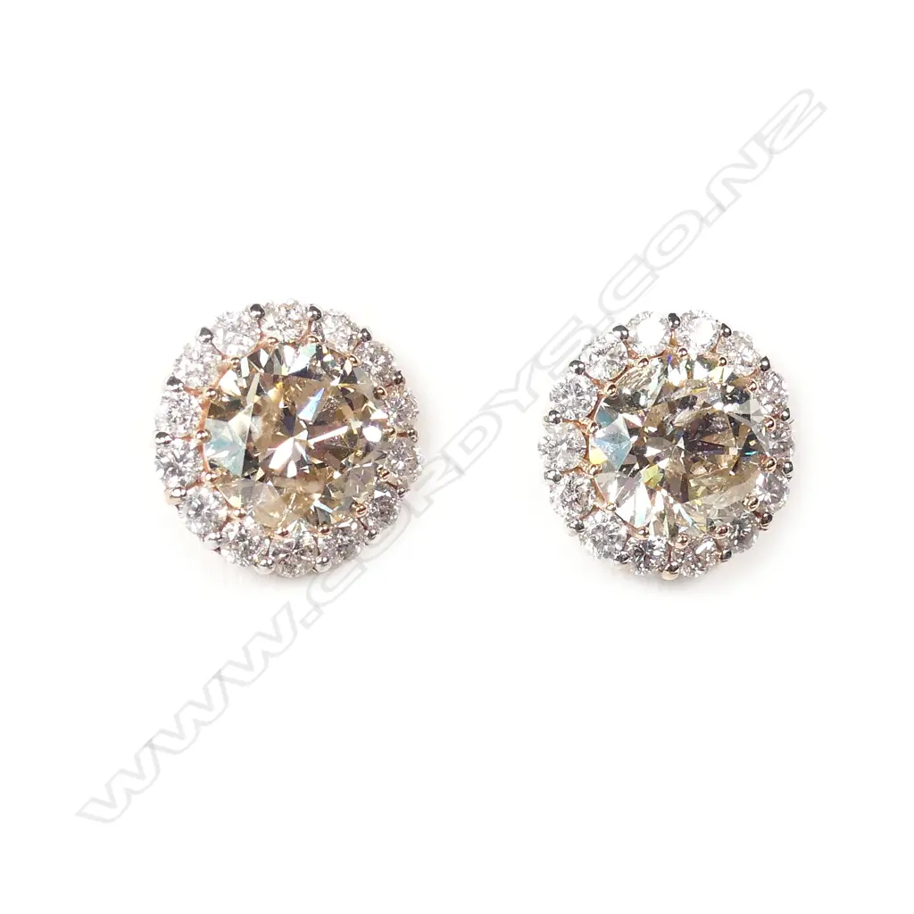 A pair of 14ct rose gold diamond stud earrings Image 1++