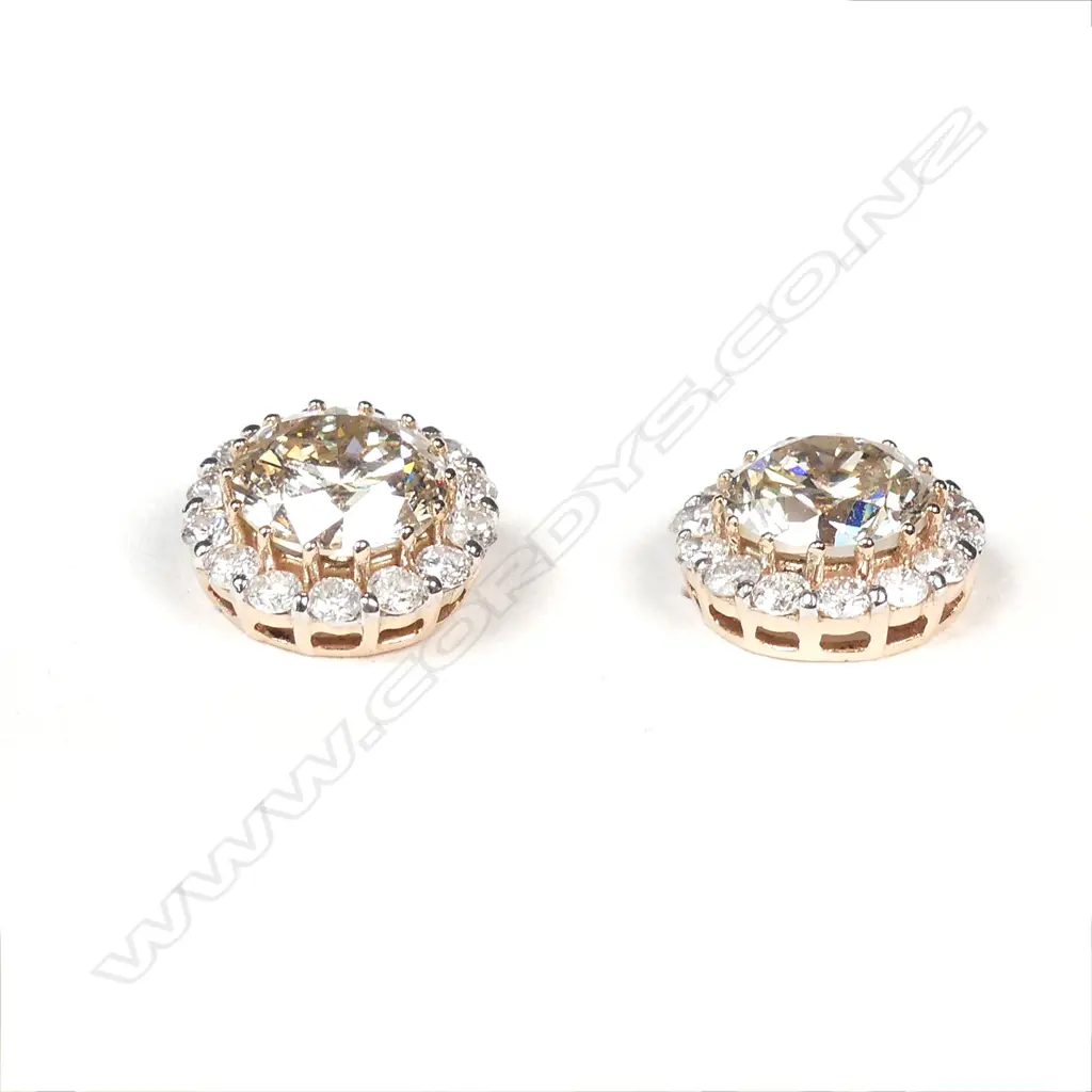 A pair of 14ct rose gold diamond stud earrings Image 1++