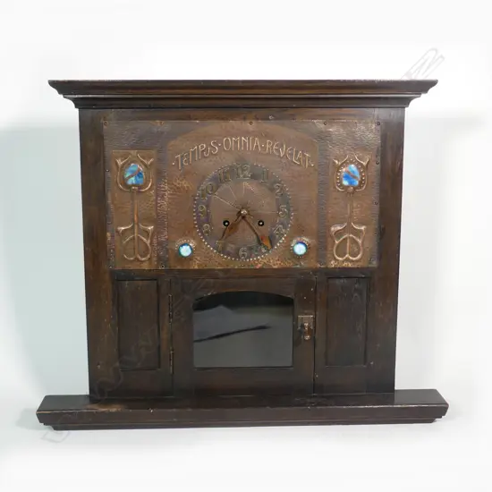 An Arts and Crafts oak and copper Liberty style mantel clock