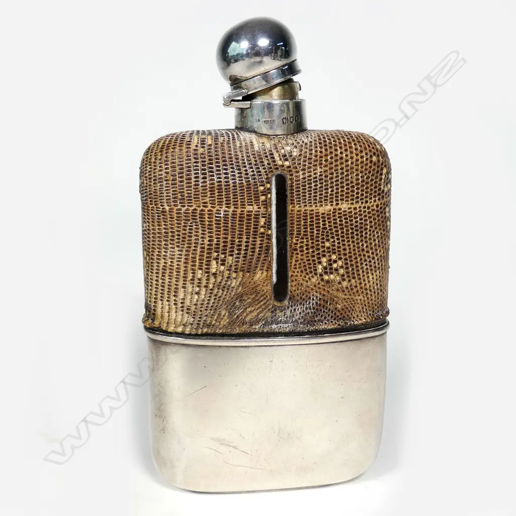A glass hip flask with silver cup cover and bayonet stopper Image 1++