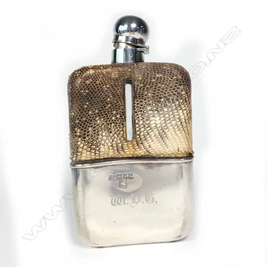 A glass hip flask with silver cup cover and bayonet stopper
