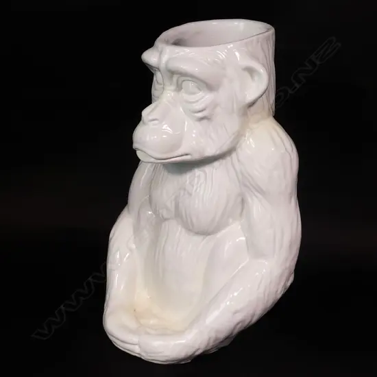 A modern white glazed ceramic walking stick stand modelled as a seated chimpanzee