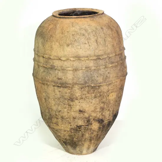 An old European terracotta tall olive oil storage jar