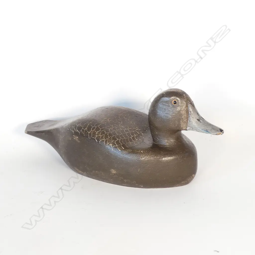 A carved and painted wooden duck decoy Image 1++