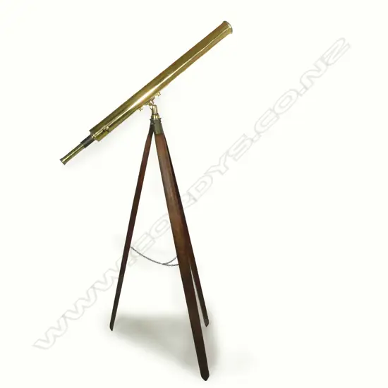 A brass telescope on wooden tripod stand