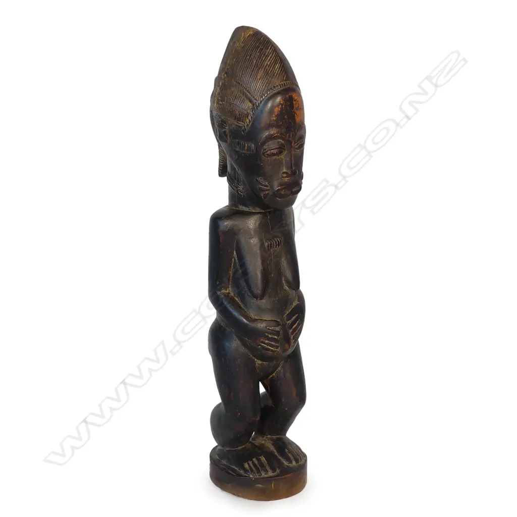 A West African carved wood female figure Image 1++