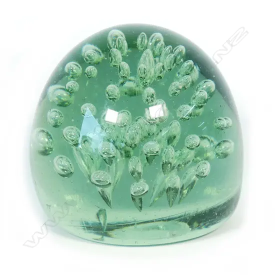 A Victorian green glass 'dump' paperweight