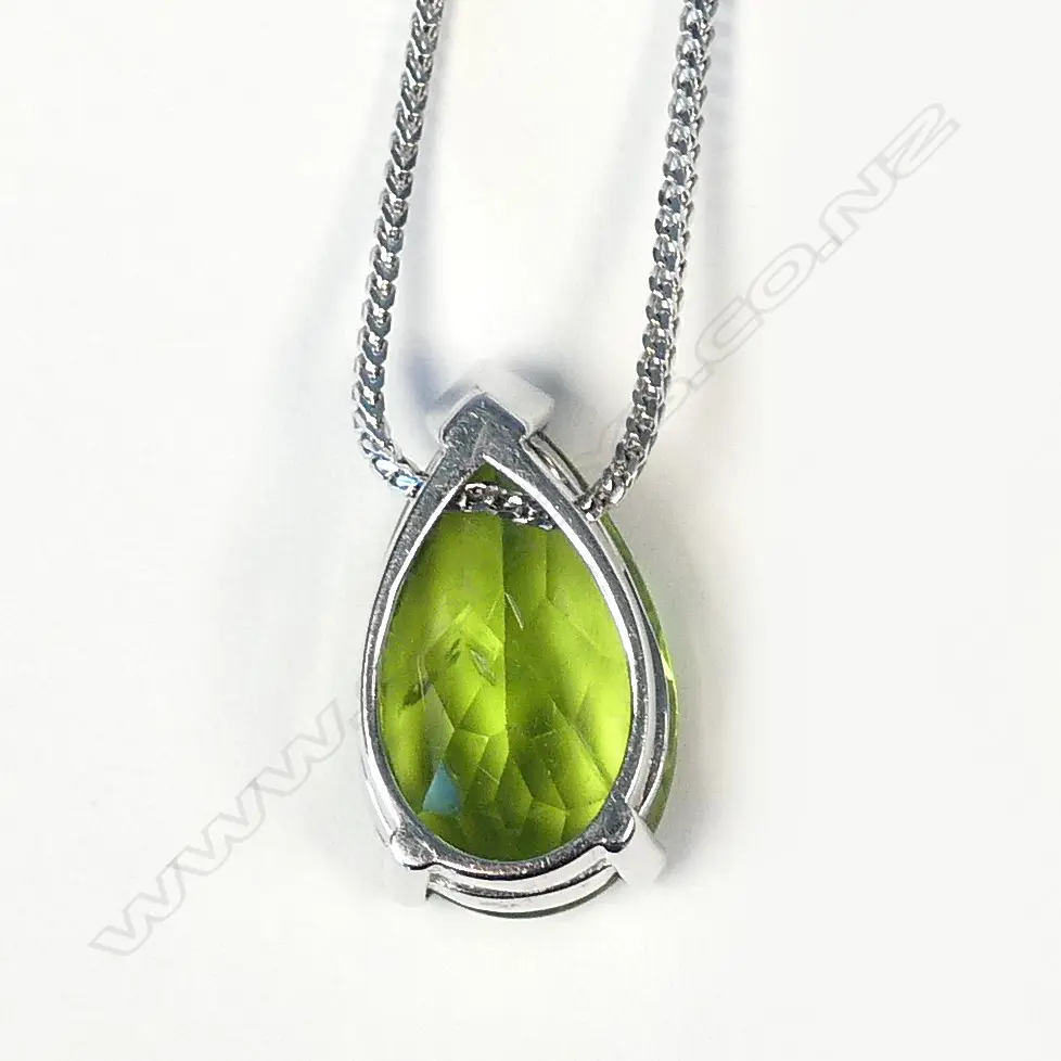 An 18ct white gold and peridot pendant Image 1++