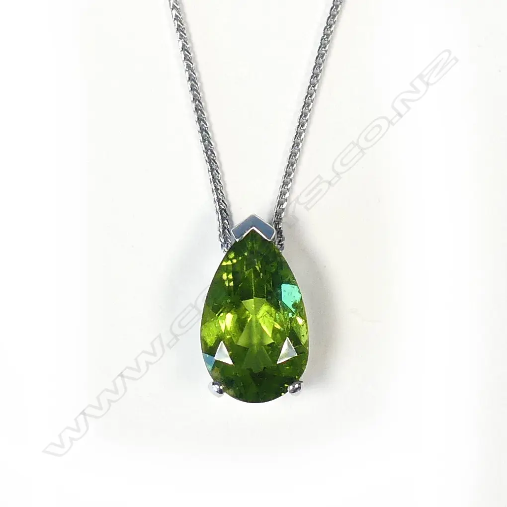 An 18ct white gold and peridot pendant Image 1++