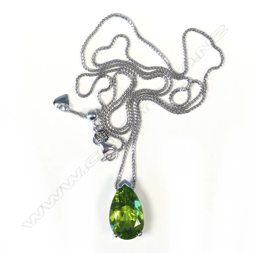 An 18ct white gold and peridot pendant Image 1++