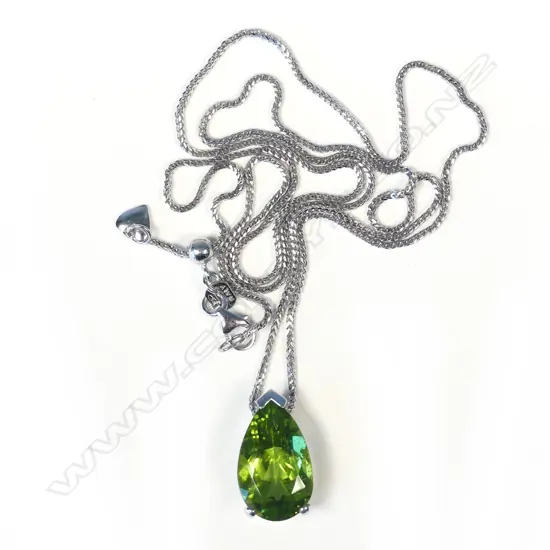 An 18ct white gold and peridot pendant