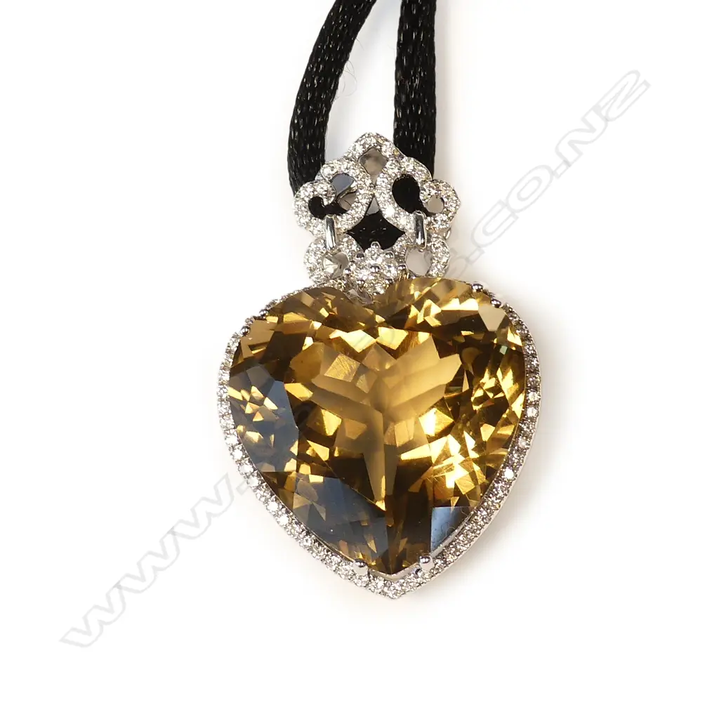 An impressive modern 18ct. white gold large green amethyst and diamond pendant Image 1++