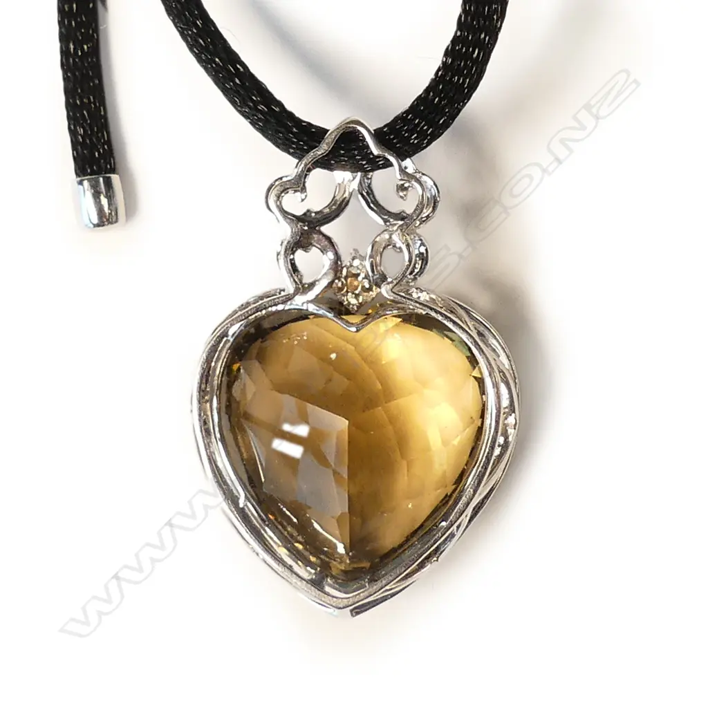 An impressive modern 18ct. white gold large green amethyst and diamond pendant Image 1++