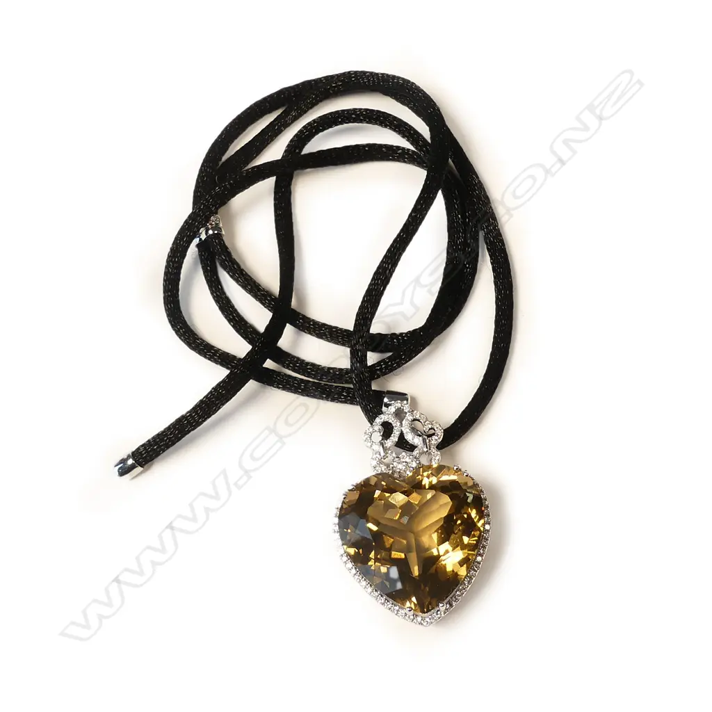 An impressive modern 18ct. white gold large green amethyst and diamond pendant Image 1++