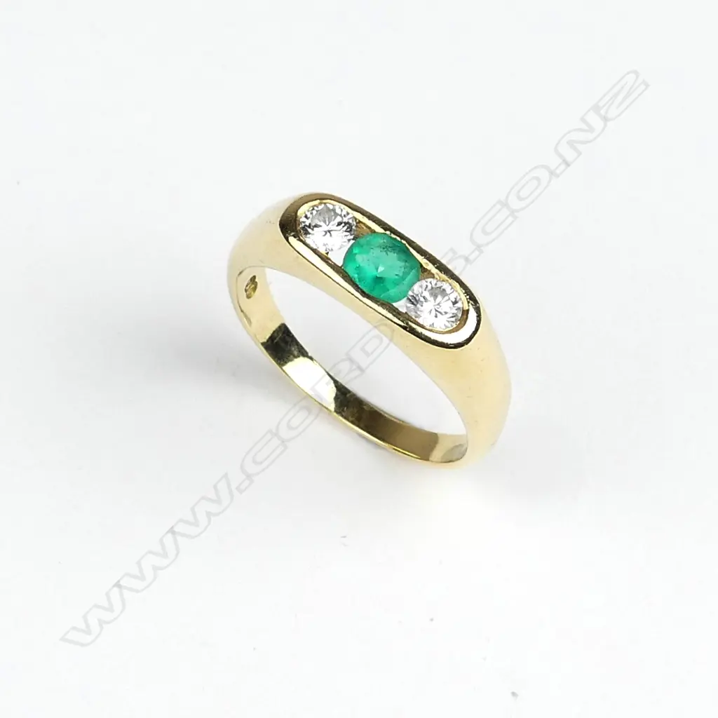 An 18ct. yellow gold emerald and diamond dress ring Image 1++