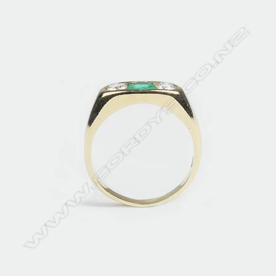 An 18ct. yellow gold emerald and diamond dress ring Image 1++
